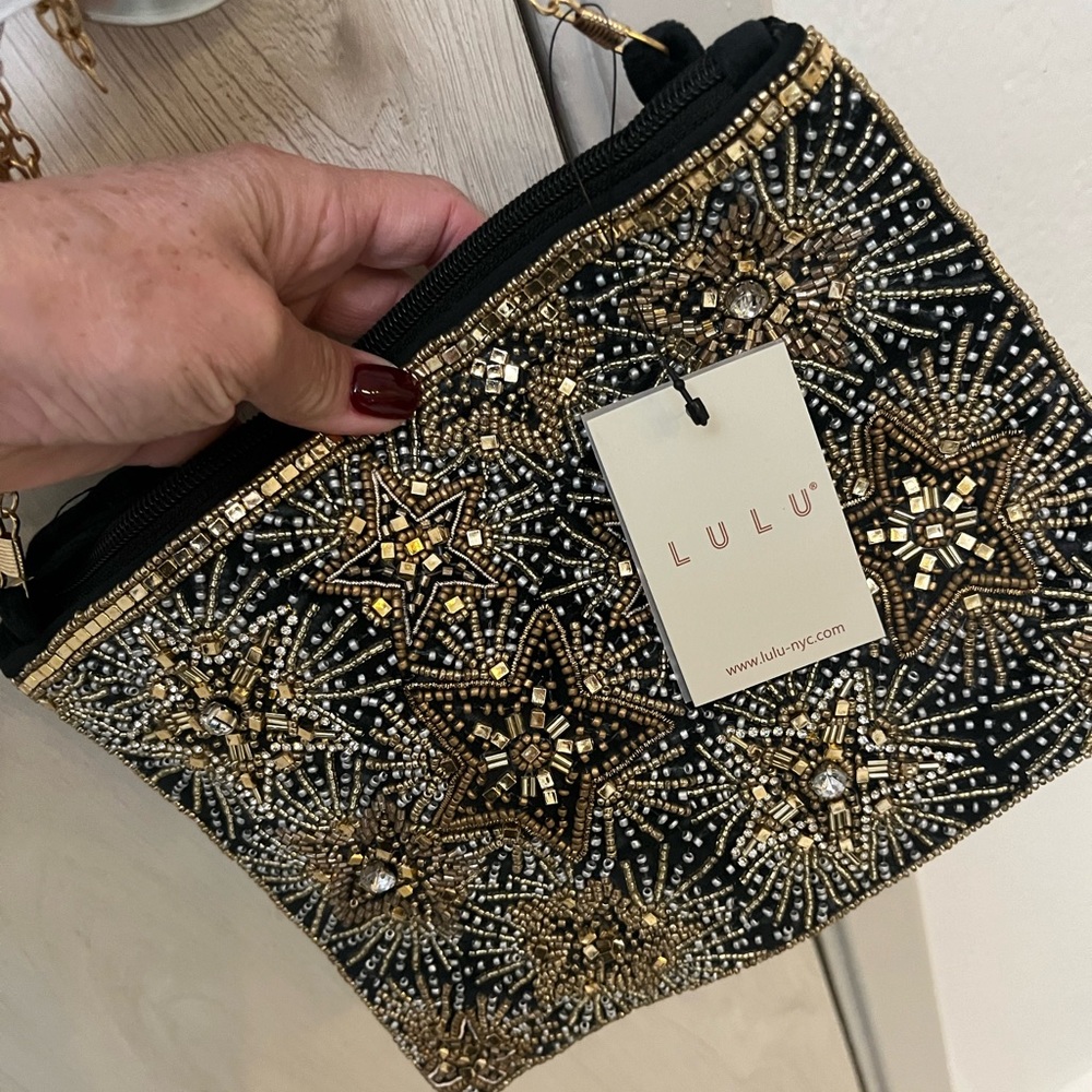 Black and gold crossbody clutch perfect for evening and partying.